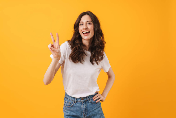 Image of happy brunette woman wearing casual clothes smiling and - Zdjęcie, obraz