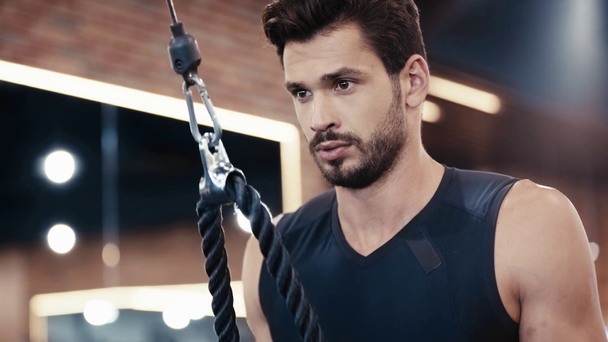 handsome man exercising in sports center  - Materiaali, video