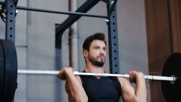 handsome sportsman weightlifting barbell in gym  - Filmagem, Vídeo