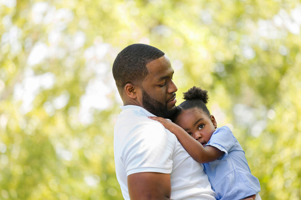 African American father parenting and talking with his daughter. - 写真・画像