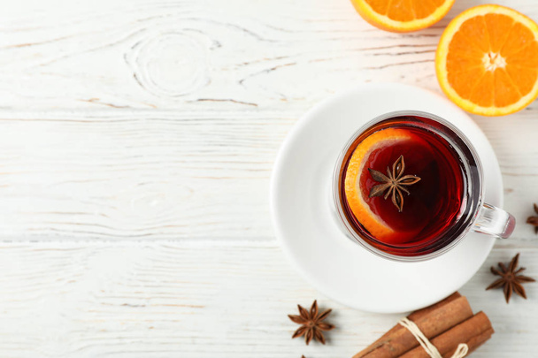 Mulled wine, orange and cinnamon on white wooden background, top - Photo, Image