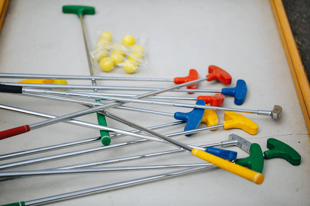 Background about teaching the game of Golf with toy Golf clubs and Golf balls, holes and flags - Foto, Bild