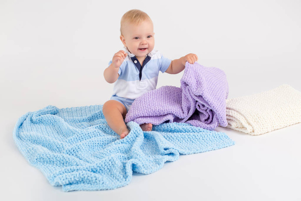 Kid with plush colored blankets on the white background - Photo, Image