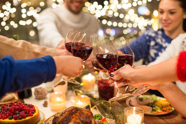 close up of friends with wine celebrate christmas - Foto, imagen