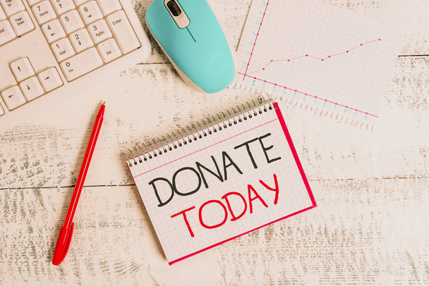 Conceptual hand writing showing Donate Today. Business photo text time to give money or goods to help a demonstrating or organization Wood desk office appliance computer equipaments charts paper slot. - Foto, Imagen