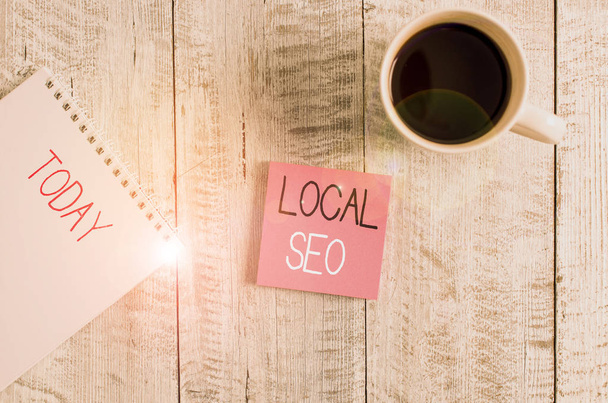 Conceptual hand writing showing Local Seo. Business photo text This is an effective way of marketing your business online Stationary placed next to a coffee cup above wooden table. - Photo, Image