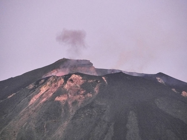 Shot of the eruption with magma, explosions, smoke and lapilli coming out from the volcano - Photo, Image