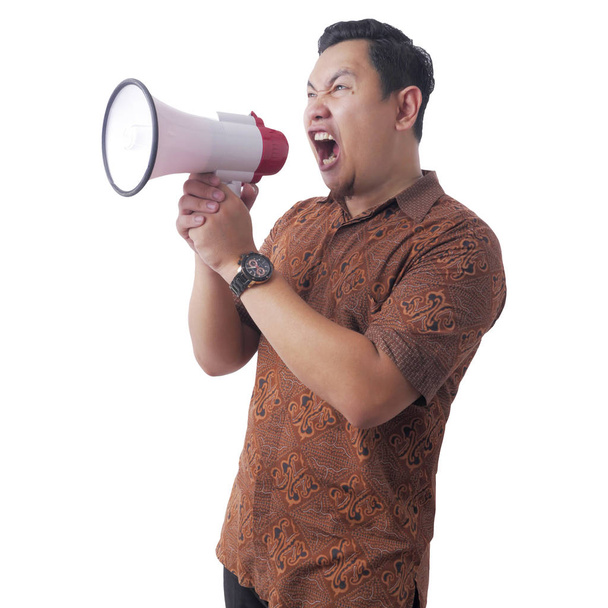 Asian Man Wearing Batik Shouting With Megaphone  - Valokuva, kuva