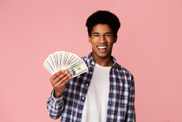 Excited african-american guy holding lots of dollars - Photo, Image