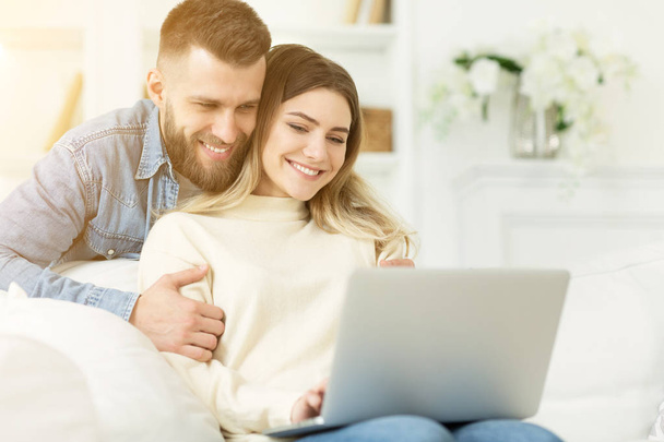 Online video-call. Happy couple using laptop, free space - Photo, Image