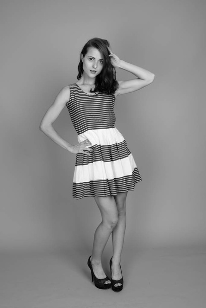 Studio shot of young beautiful woman in black and white - Zdjęcie, obraz