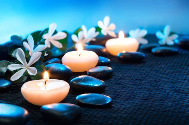 Candles and black stones on black mat - Photo, Image