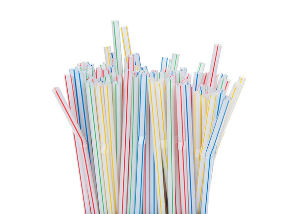 Close up on tops of many colorful striped plastic straws facing upwards. California just became the first US state to ban plastic straws in restaurants, unless customers ask for one. - Photo, Image