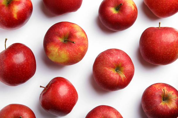 Ripe juicy red apples on white background, top view - Fotó, kép