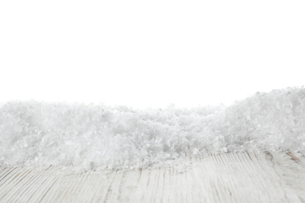 Heap of snow on wooden surface against white background. Christmas season - Foto, Imagen