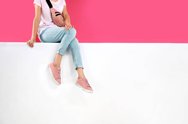 Woman wearing stylish shoes on color background, closeup - Fotoğraf, Görsel