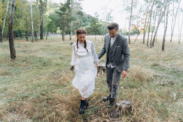 beautiful pregnant woman in white dress with handsome man in Birch Grove         - Photo, Image