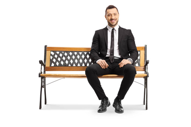 Young businessman sitting on a bench and smiling - Foto, Imagem
