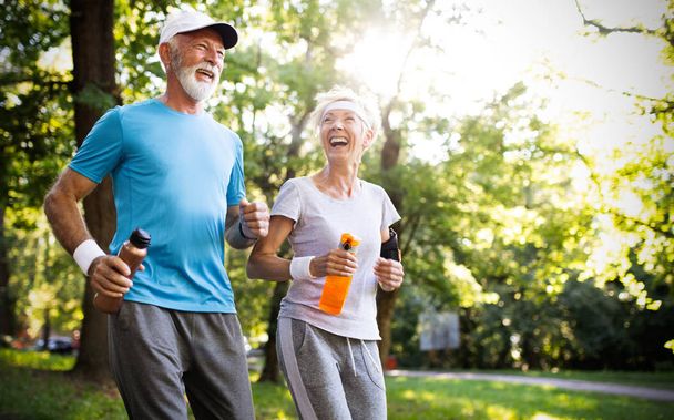 Active and sporty senior couple engaging in healthy sports activies - Фото, зображення