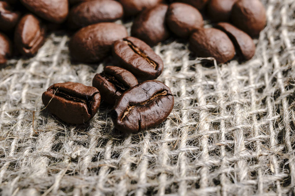 Coffee beans on burlap background - Φωτογραφία, εικόνα