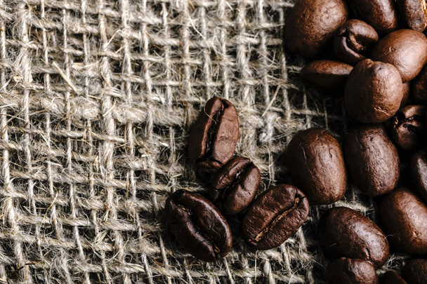 Coffee beans on burlap background - Foto, afbeelding