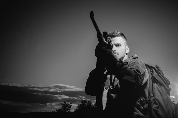 Barrel of a gun. Hunter with shotgun gun on hunt. Hunter with Powerful Rifle with Scope Spotting Animals. - 写真・画像
