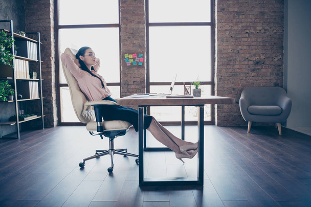 Full length body size photo of resting relaxing girl employed just for work in transnational company wearing formally heels shoes sitting at desktop - Foto, imagen