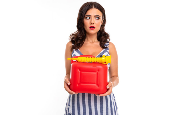 Woman in dress posing with gas canister against white background  - Photo, Image