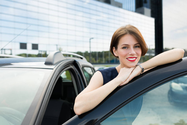 young beautiful woman posing near car  - Zdjęcie, obraz