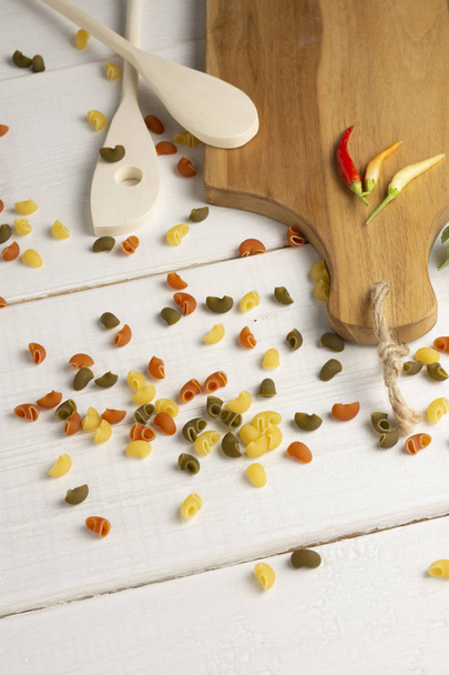 Red Chili Peppers, orange and yellow on wooden cutting board. - Foto, imagen