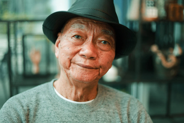 Asian senior man drinking coffee in coffee shop cafe  - Фото, зображення