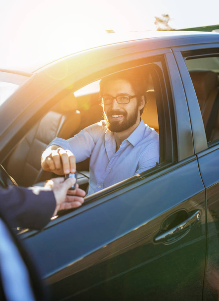 Young and handsome businessman buying used car. - Фото, зображення