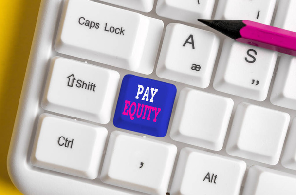 Text sign showing Pay Equity. Conceptual photo eliminating sex and race discrimination in wage systems White pc keyboard with empty note paper above white background key copy space. - Photo, Image