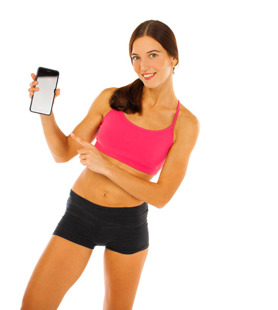 Cheerful young fitness woman showing blank smartphone screen iso - Fotografie, Obrázek