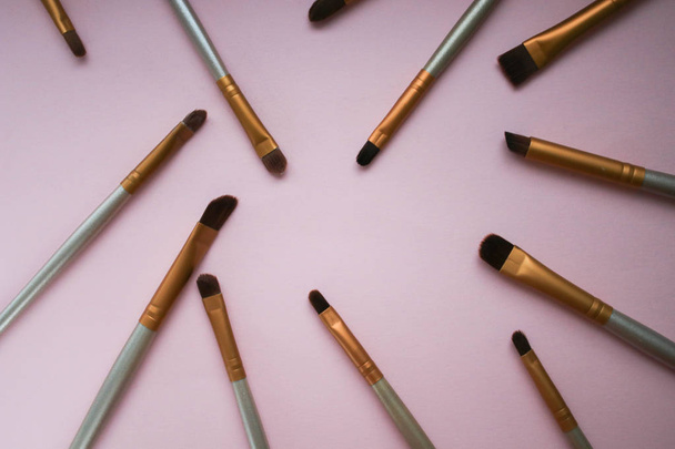 Makeup brushes on pink background - Фото, зображення