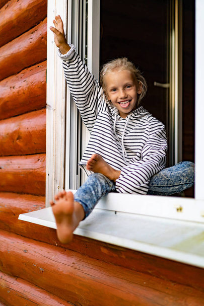 blonde little girl at weekend in the country, happy childhood concept - Фото, изображение