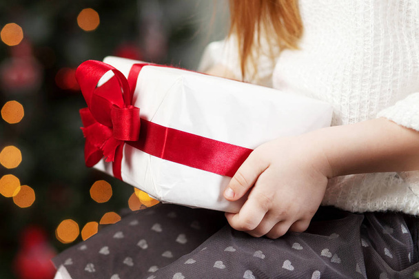 Child's  hands holding gift box. Christmas, new year, birthday c - 写真・画像