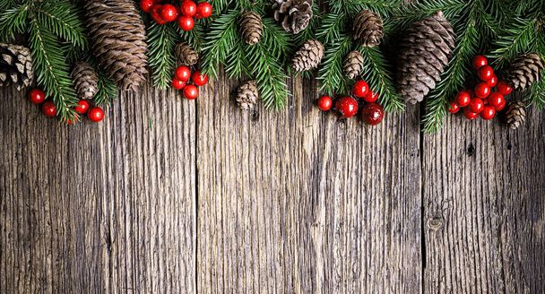 Christmas tree branches on rustic wooden planks background - Фото, изображение