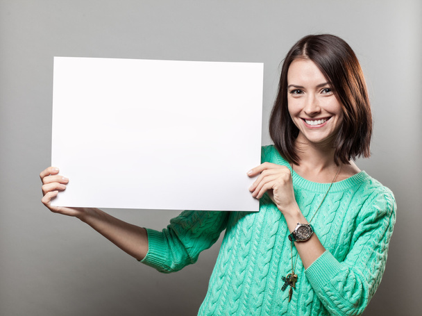 Young brunette woman holding blank sign - Foto, imagen