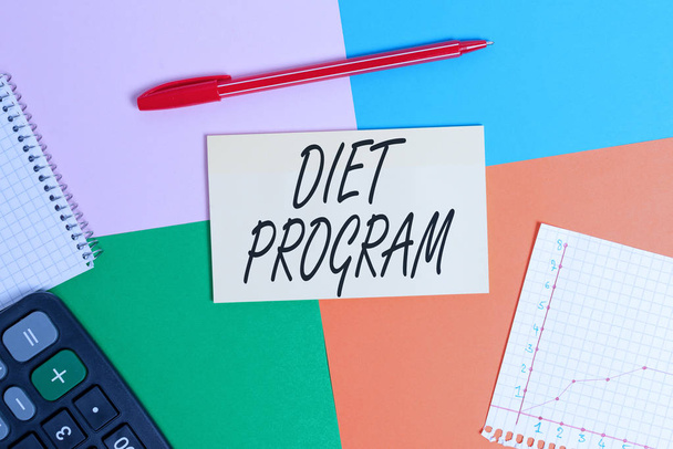 Handwriting text Diet Program. Concept meaning practice of eating food in a regulated and supervised fashion Office appliance colorful square desk study supplies empty paper sticker. - Photo, Image
