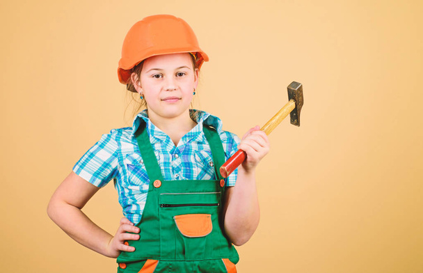 Future profession. Builder engineer architect. Kid builder girl. Build your future yourself. Initiative child girl hard hat helmet builder worker. Tools to improve yourself. Child care development - Photo, Image
