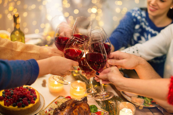 close up of friends with wine celebrate christmas - 写真・画像