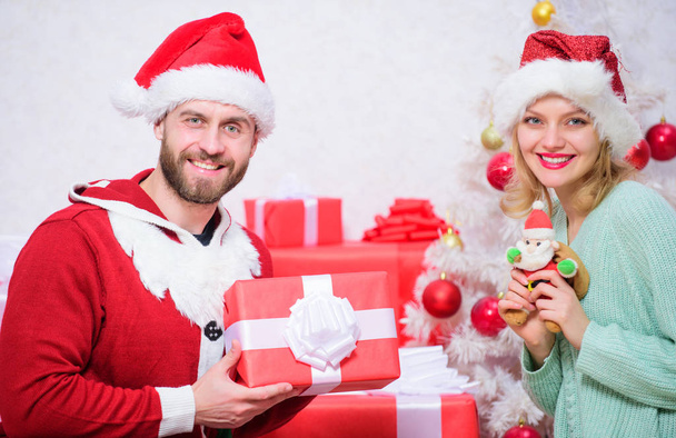 Family prepared christmas surprise. Dreams come true. Opening christmas present. Couple in love enjoy christmas holiday celebration. Loving couple smiling unpacking gift christmas tree background - Фото, зображення