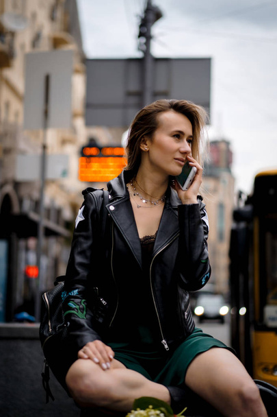 Young beautiful woman walks around the city in Europe, street photo, female posing in the city center - Φωτογραφία, εικόνα