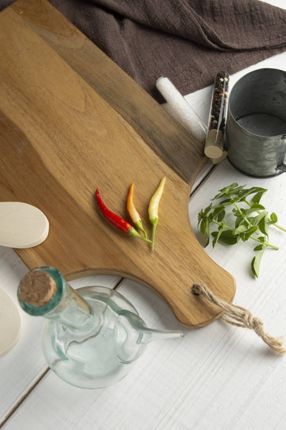 Red Chili Peppers, orange and yellow on wooden cutting board. - Photo, Image