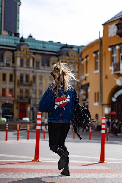 Young beautiful woman walks around the city in Europe, street photo, female posing in the city center - Fotoğraf, Görsel