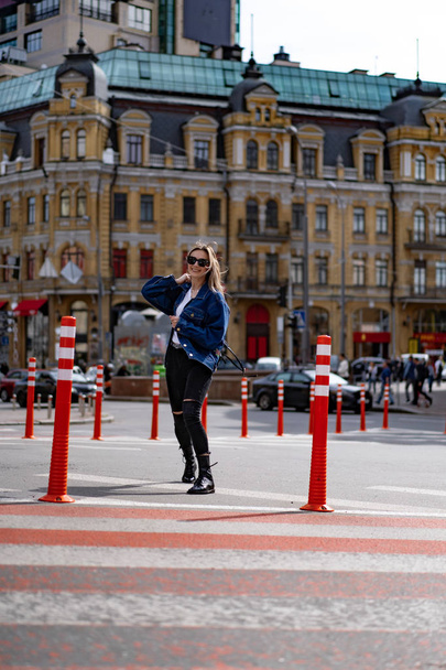 Young beautiful woman walks around the city in Europe, street photo, female posing in the city center - Fotografie, Obrázek