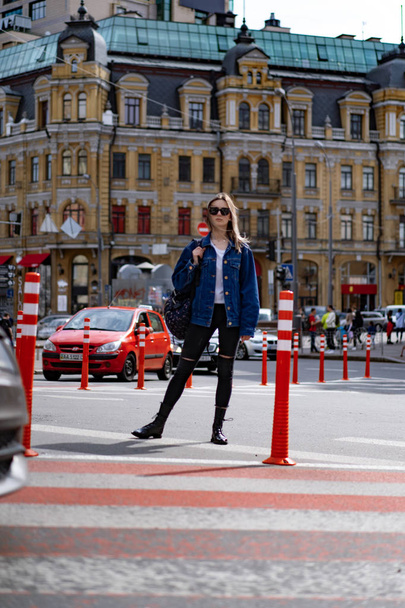 Young beautiful woman walks around the city in Europe, street photo, female posing in the city center - Foto, Imagen