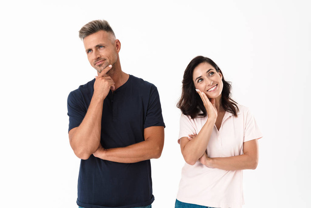 Pensive attractive couple wearing casual outfit standing - Φωτογραφία, εικόνα
