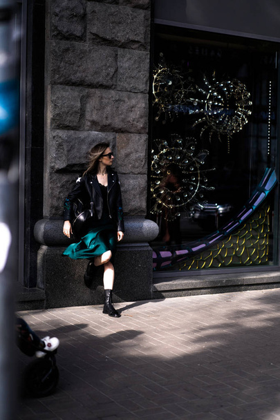 Young beautiful woman walks around the city in Europe, street photo, female posing in the city center - Φωτογραφία, εικόνα
